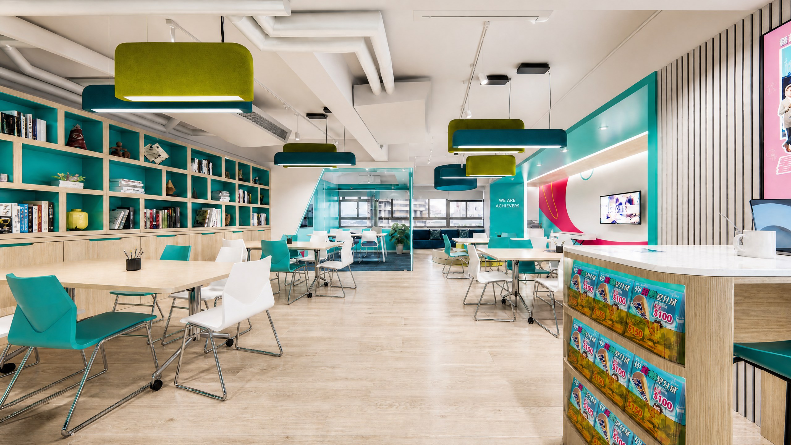 Achievers Coaching Academy open study area with bespoke bookshelves, round-table seating and pendant lights