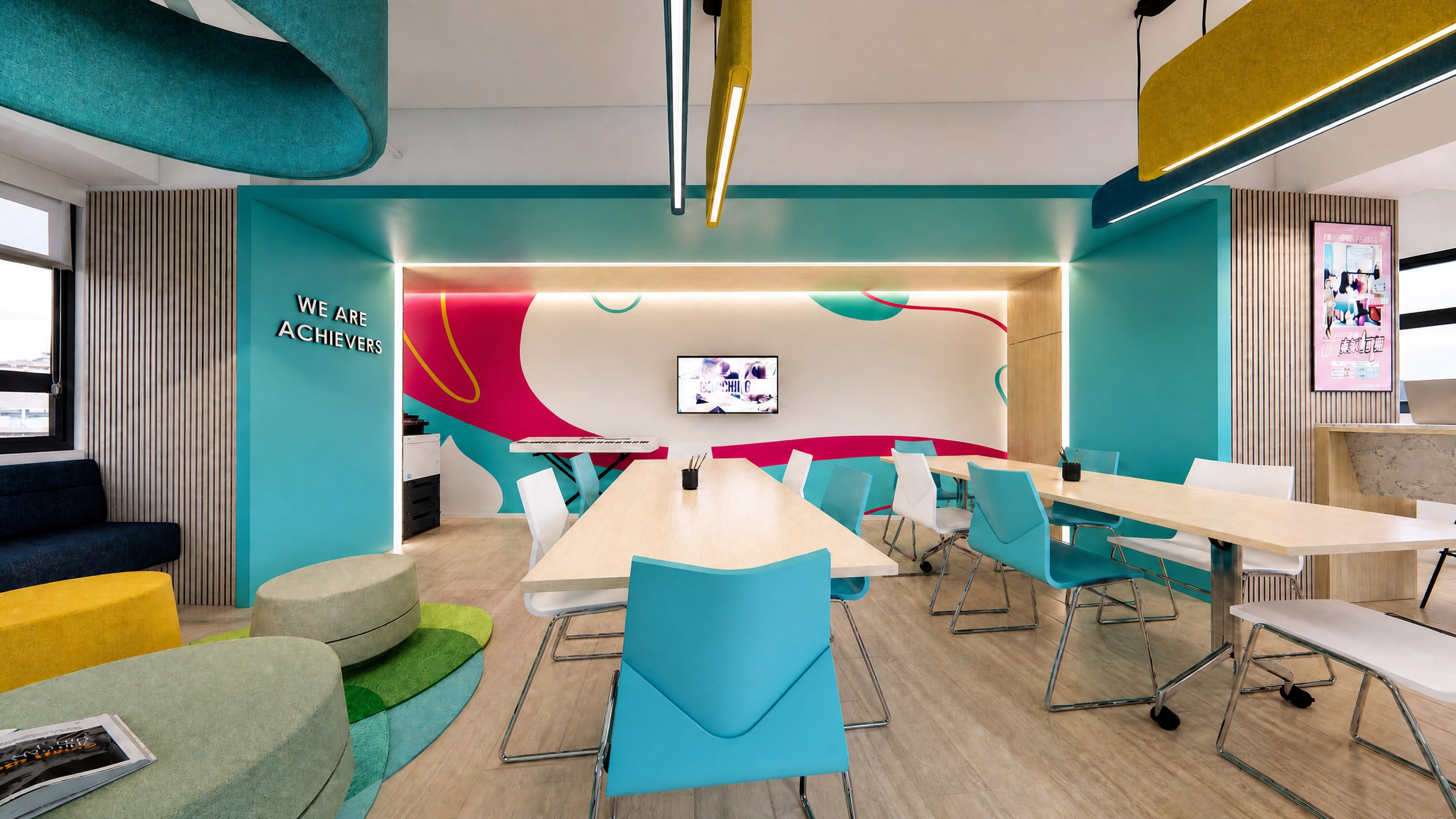 Achievers Coaching Academy activity area with brand-coloured walls, a long table and pendant lighting