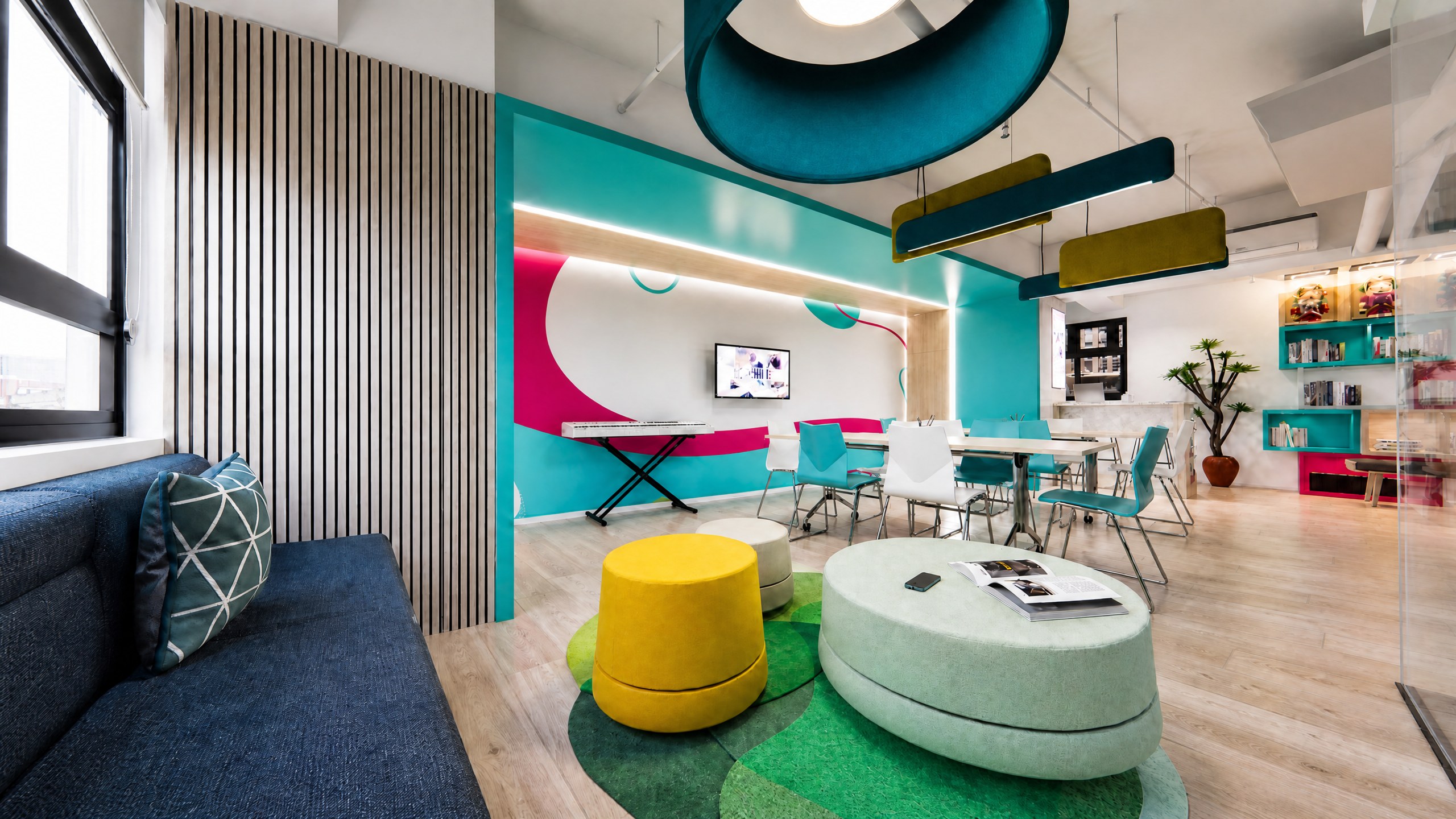 Achievers Coaching Academy lounge with a sofa, colourful upholstered seating and a slatted timber wall