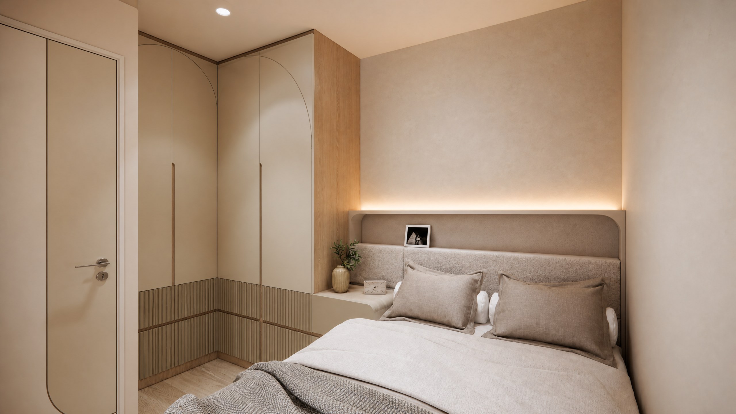 Yan Shing Court bedroom with curved wardrobe doors, an upholstered headboard and indirect lighting
